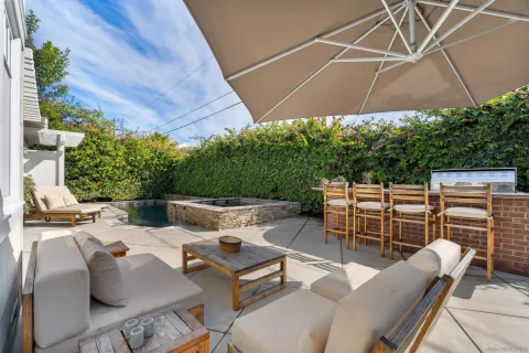 a view of a patio with a table and chairs under an umbrella
