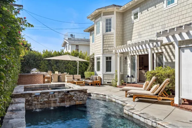 a view of a dinning tables and chairs in the patio in front of a house