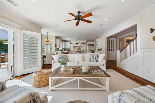 a living room with furniture kitchen view and a window