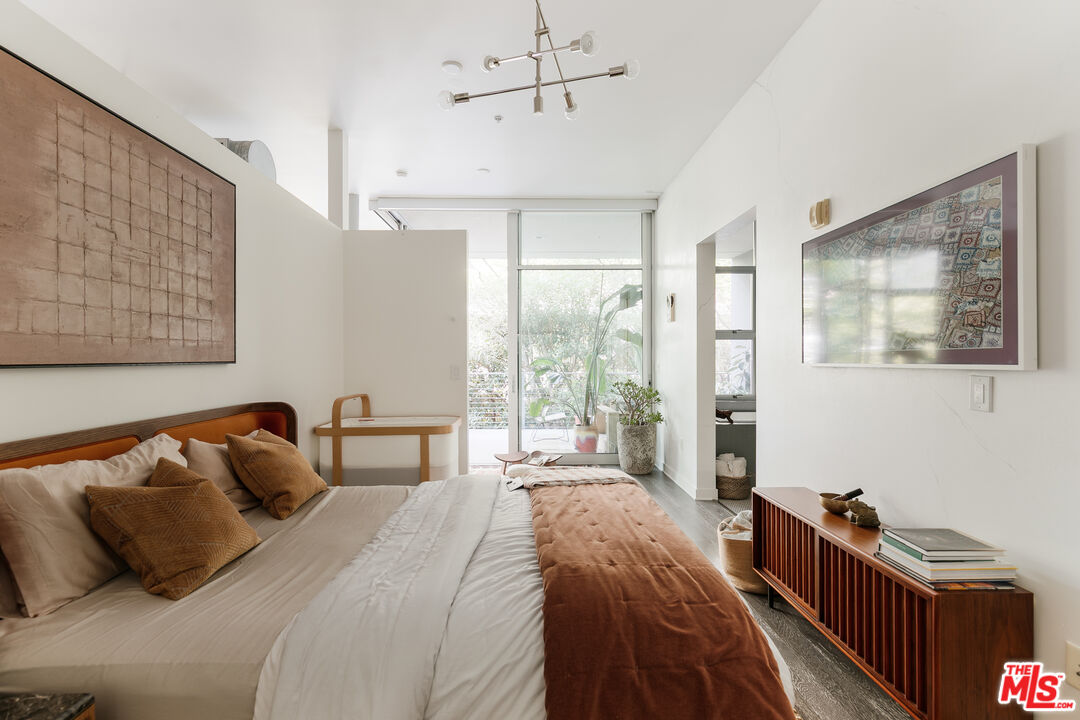 4080 Glencoe Avenue, Unit 219 Marina del Rey, CA 90292 - Photo 17 of 31 a bedroom with a bed and wooden floor
