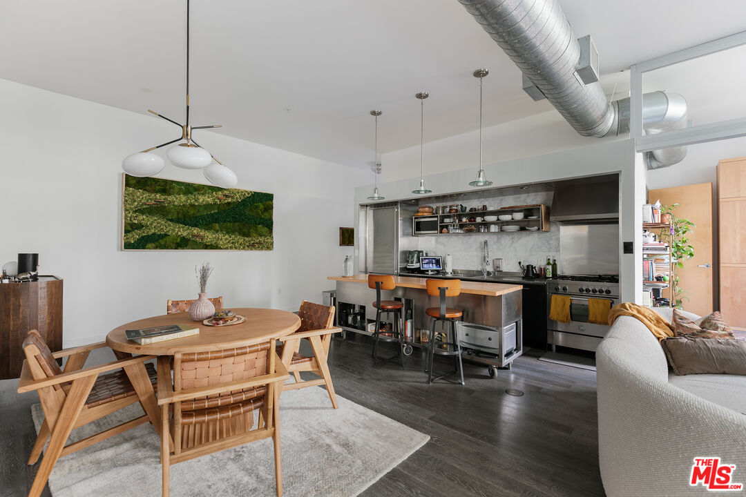 4080 Glencoe Avenue, Unit 219 Marina del Rey, CA 90292 - Photo 4 of 31 a living room with furniture a flat screen tv and kitchen view
