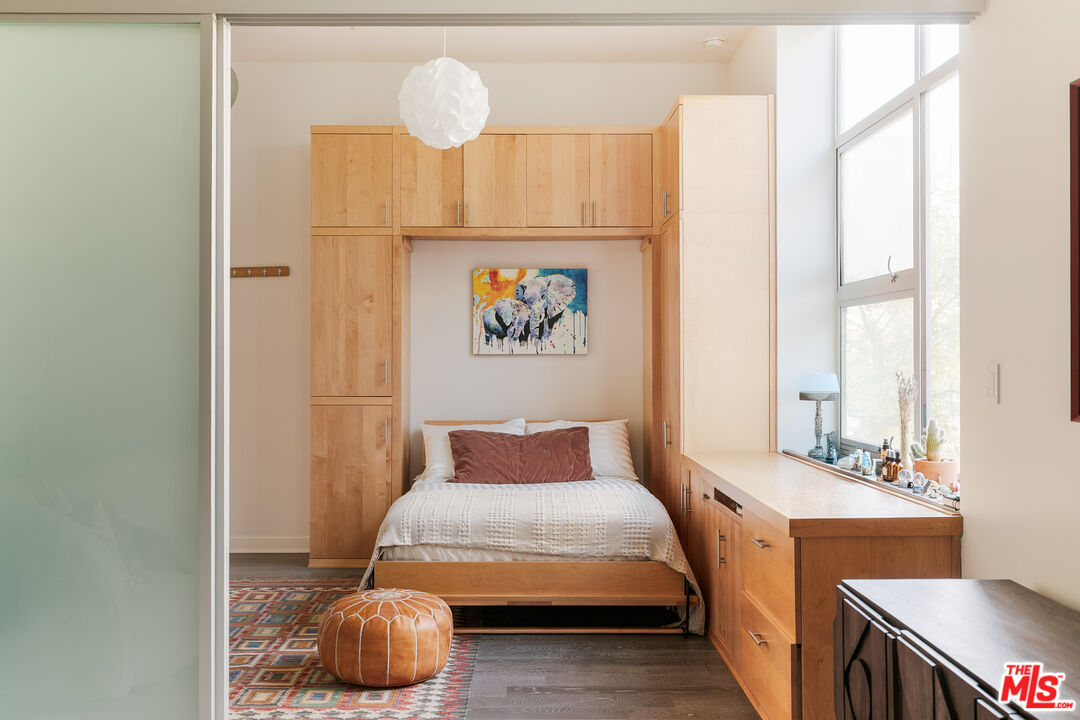 4080 Glencoe Avenue, Unit 219 Marina del Rey, CA 90292 - Photo 8 of 31 a bedroom with a bed and a chandelier