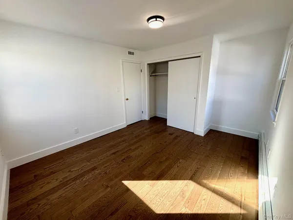 an empty room with wooden floor