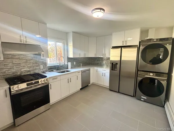 a kitchen with a stove a washer and dryer