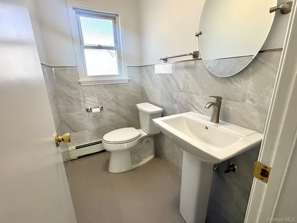 a bathroom with a sink toilet and a mirror