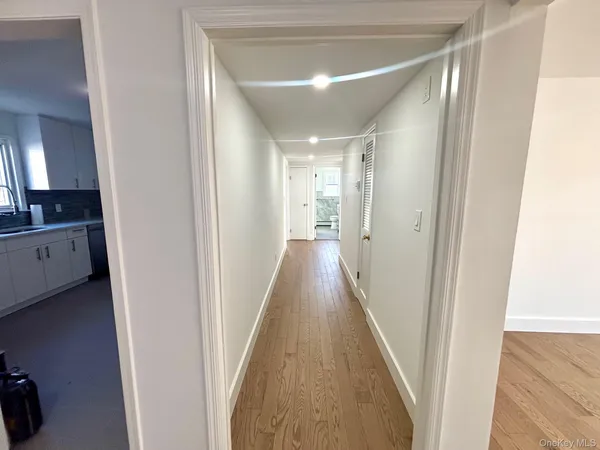 a view of a hallway with a hardwood floor