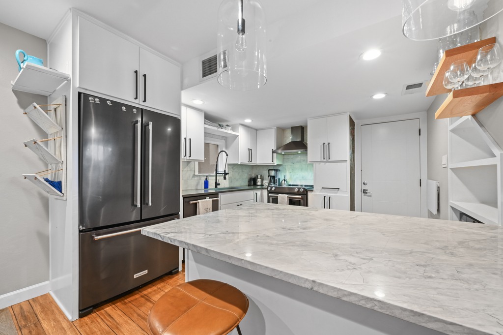 2101 Airole Way, Unit B Austin, TX 78704 - Photo 13 of 28 a kitchen with stainless steel appliances granite countertop a refrigerator a sink and a stove
