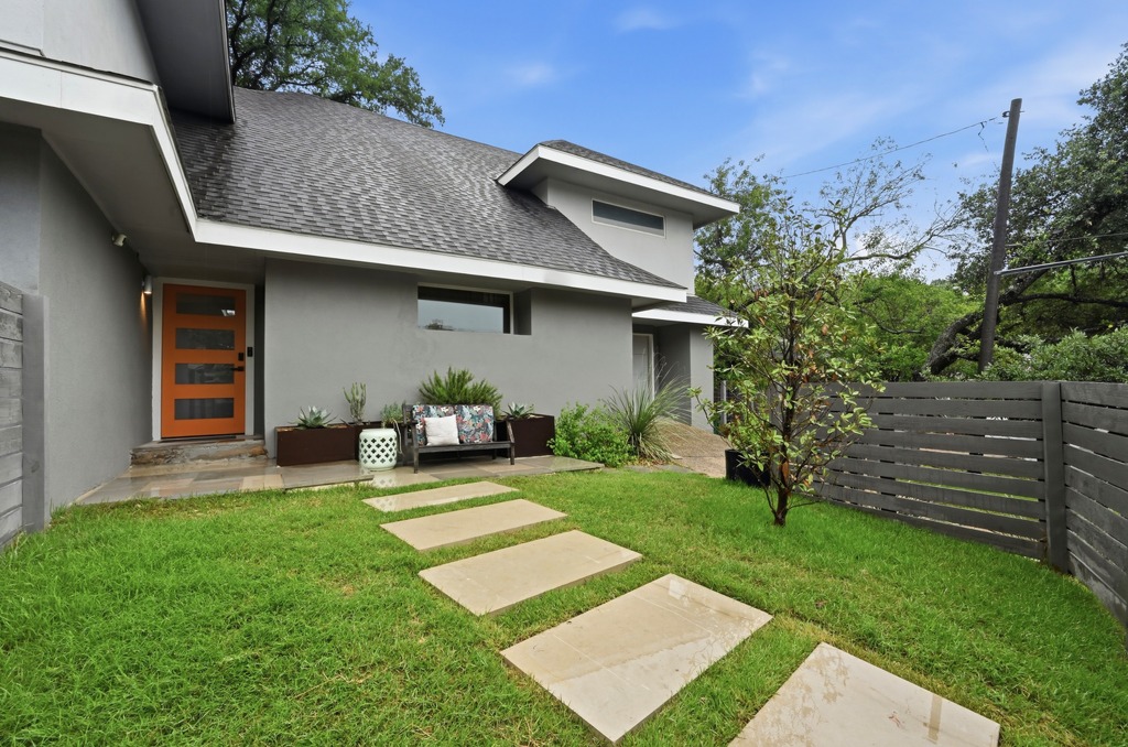2101 Airole Way, Unit B Austin, TX 78704 - Photo 2 of 28 a view of a backyard with table and chairs and wooden fence