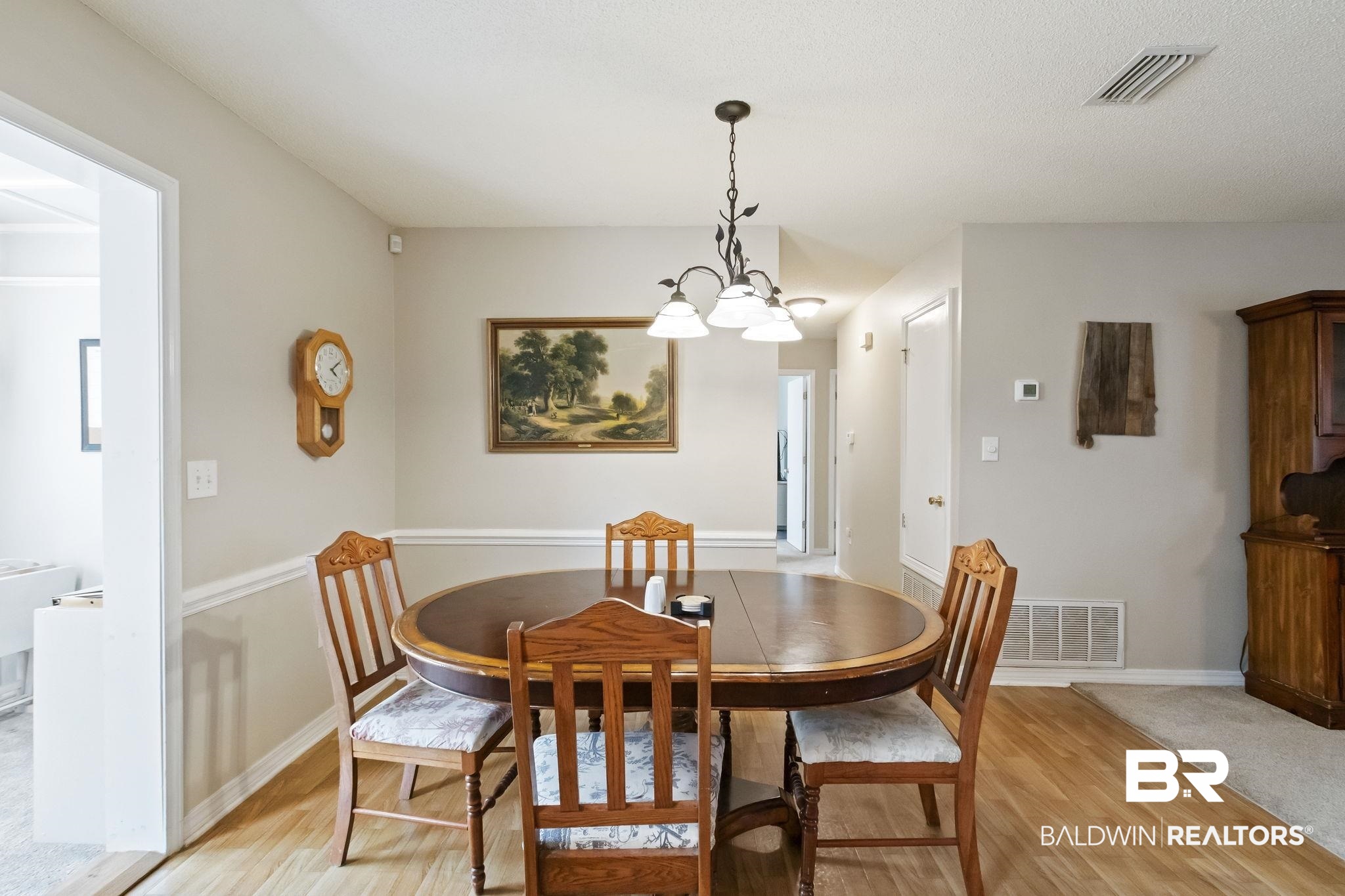 14031 Brook Hollow Road Summerdale, AL 36580 - Photo 22 of 56 Dining space with light hardwood / wood-style flooring and an inviting chandelier