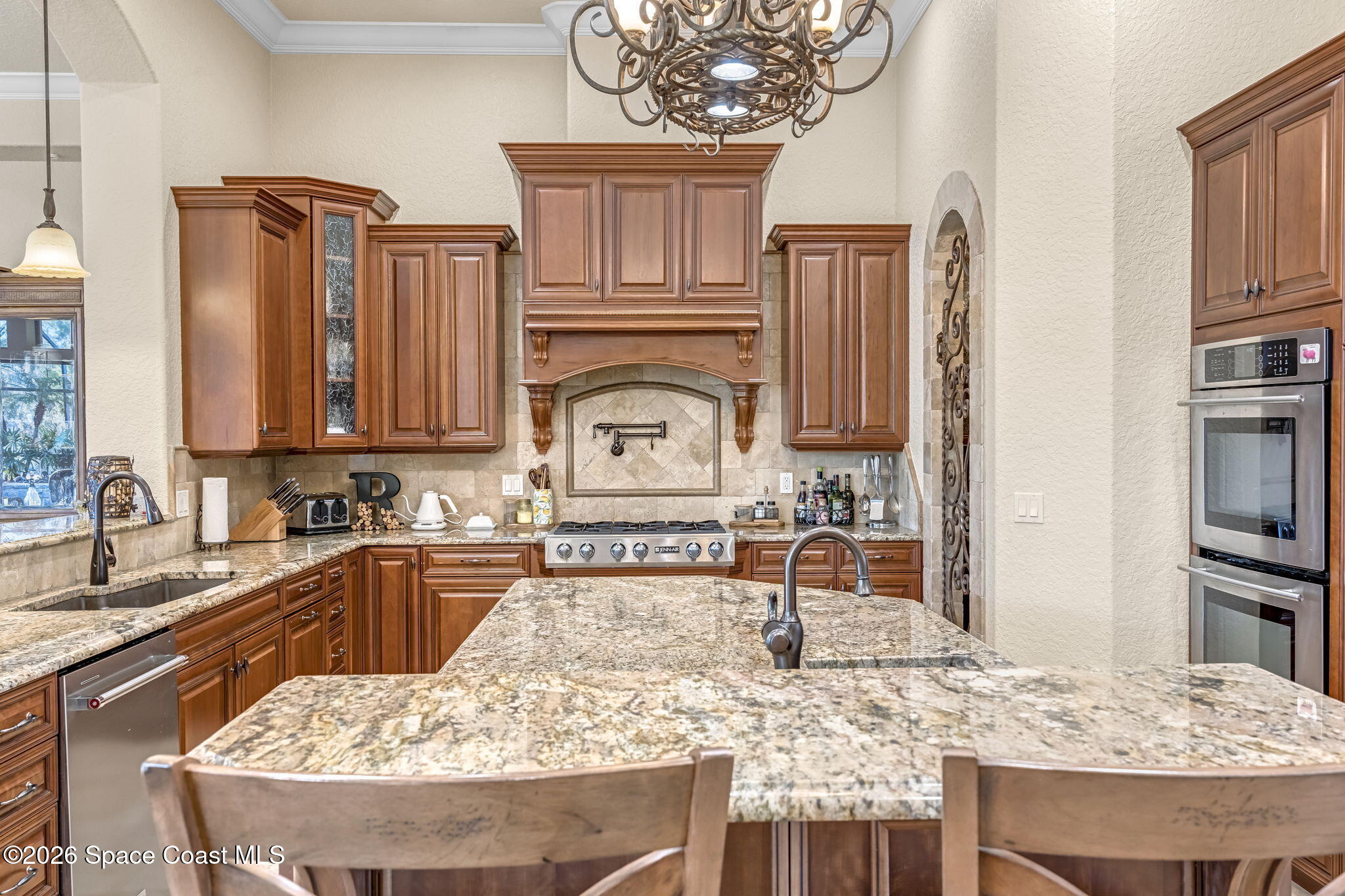 5454 Riveredge Drive Titusville, FL 32780 - Photo 18 of 70 a kitchen with kitchen island granite countertop a sink stove and refrigerator