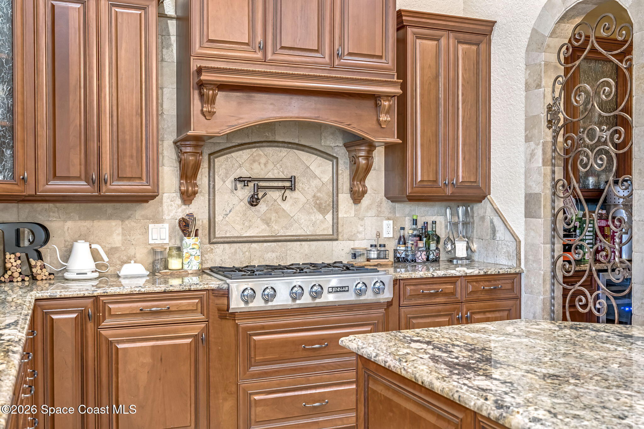 5454 Riveredge Drive Titusville, FL 32780 - Photo 19 of 70 a kitchen with stainless steel appliances granite countertop a stove and a refrigerator
