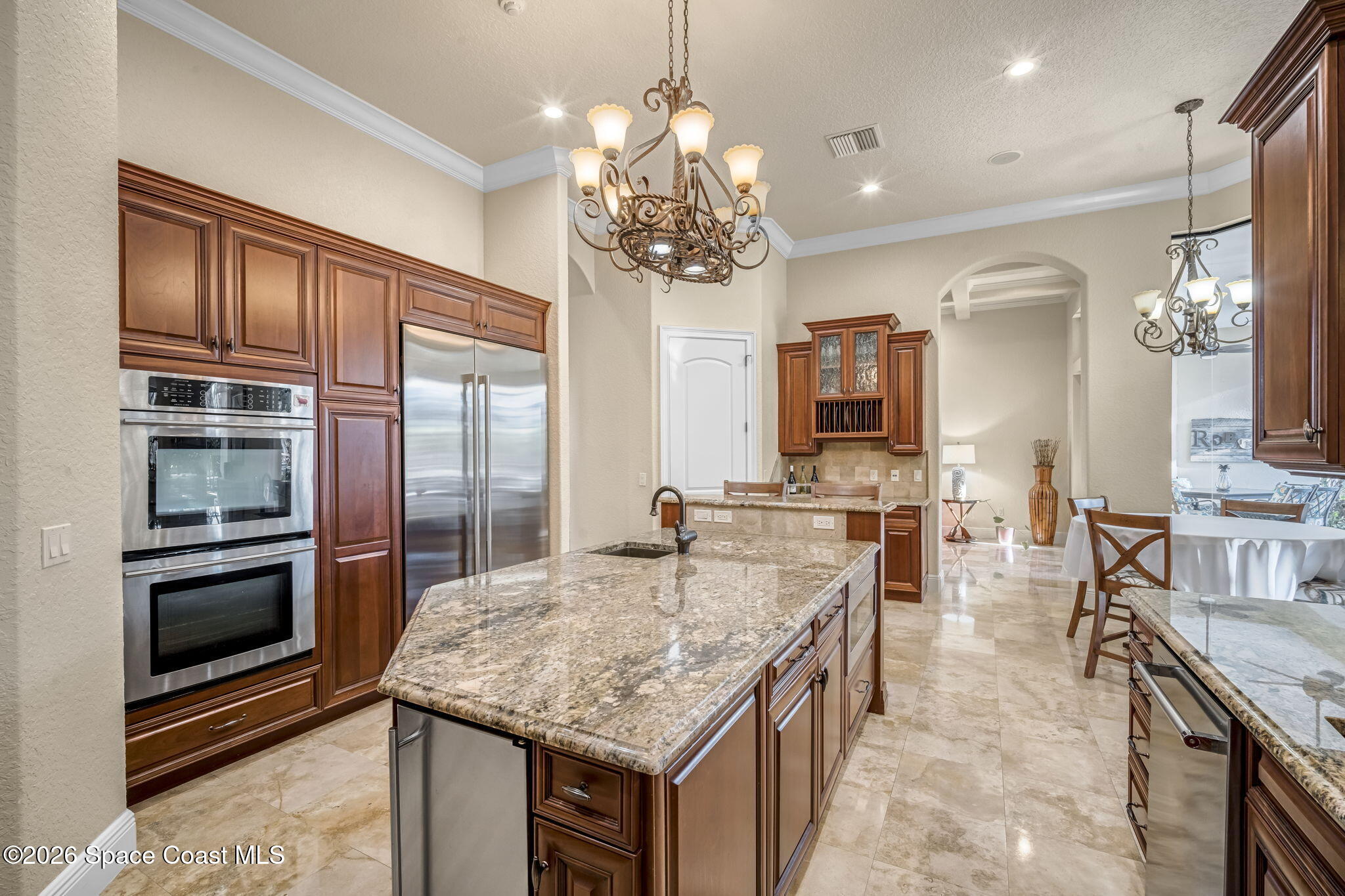 5454 Riveredge Drive Titusville, FL 32780 - Photo 22 of 70 a kitchen with kitchen island granite countertop a stove and cabinets