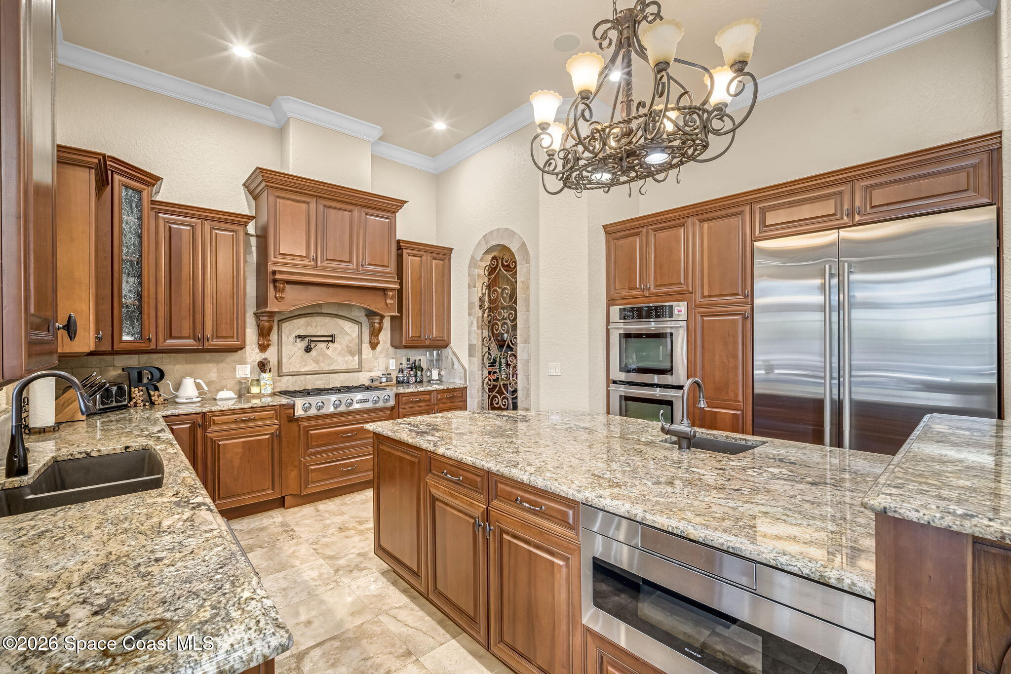 5454 Riveredge Drive Titusville, FL 32780 - Photo 25 of 70 a kitchen with stainless steel appliances granite countertop a sink stove and refrigerator