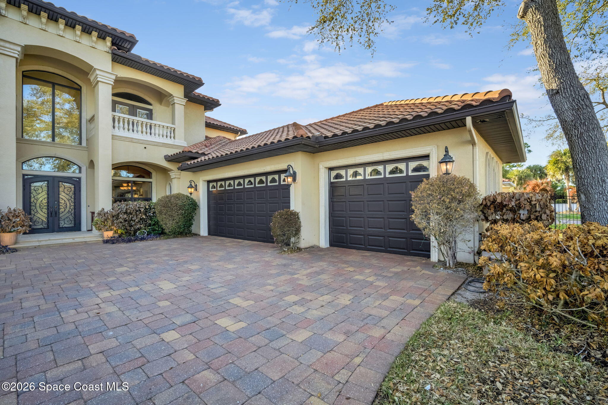 5454 Riveredge Drive Titusville, FL 32780 - Photo 3 of 70 a front view of a house with a yard and garage
