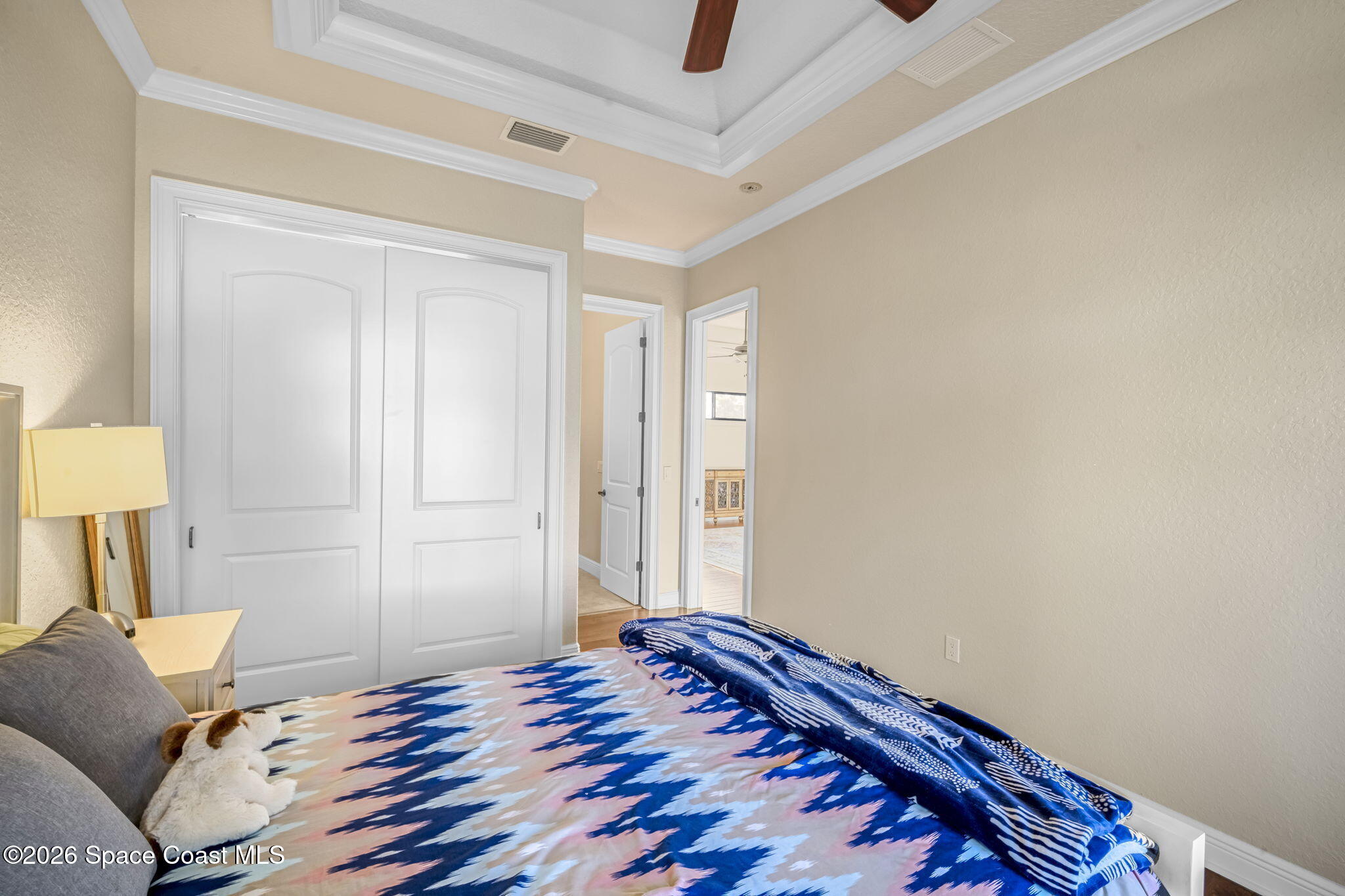 5454 Riveredge Drive Titusville, FL 32780 - Photo 35 of 70 a bedroom with a bed and a lamp on the dresser