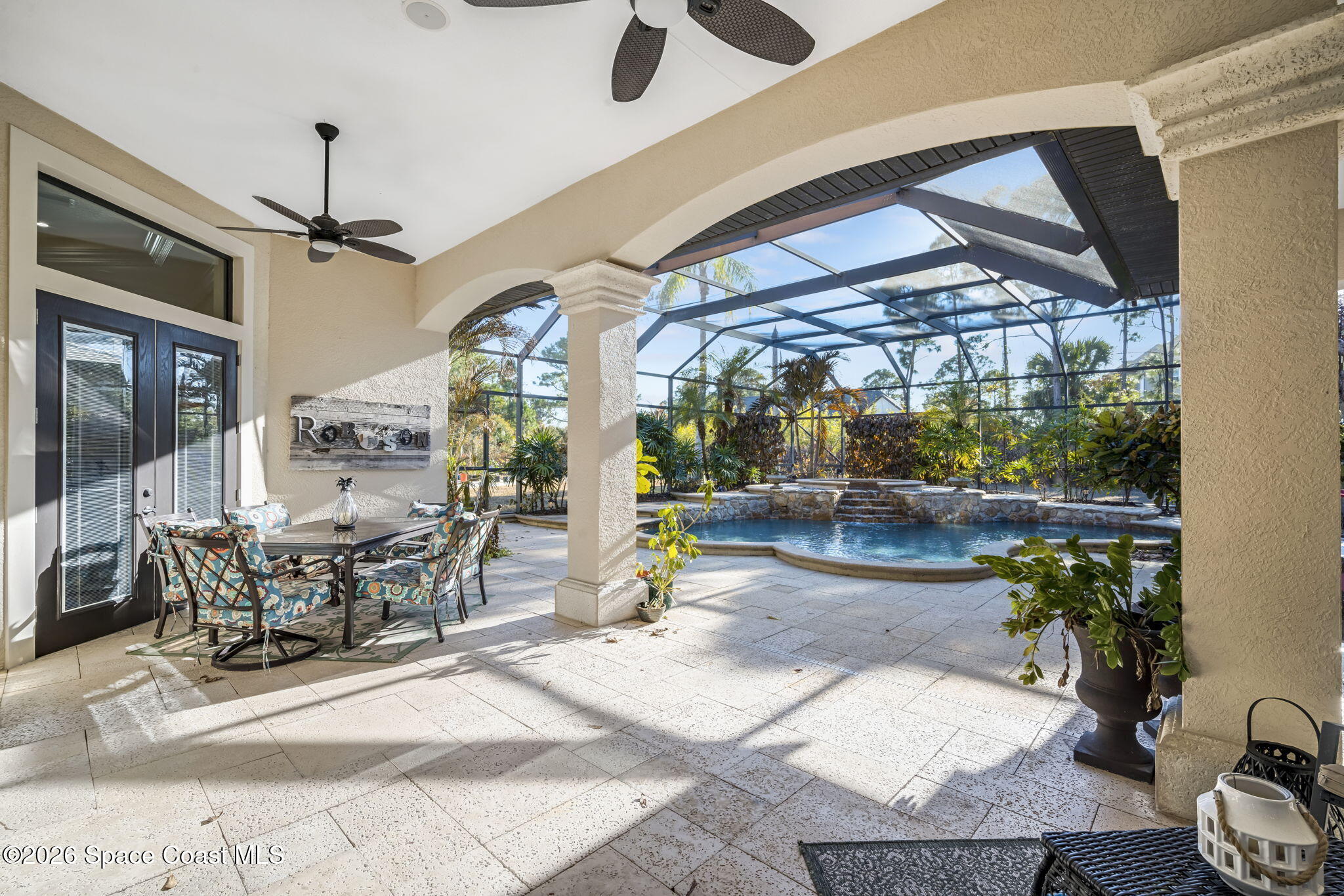 5454 Riveredge Drive Titusville, FL 32780 - Photo 47 of 70 a view of a patio with table and chairs potted plants with wooden floor