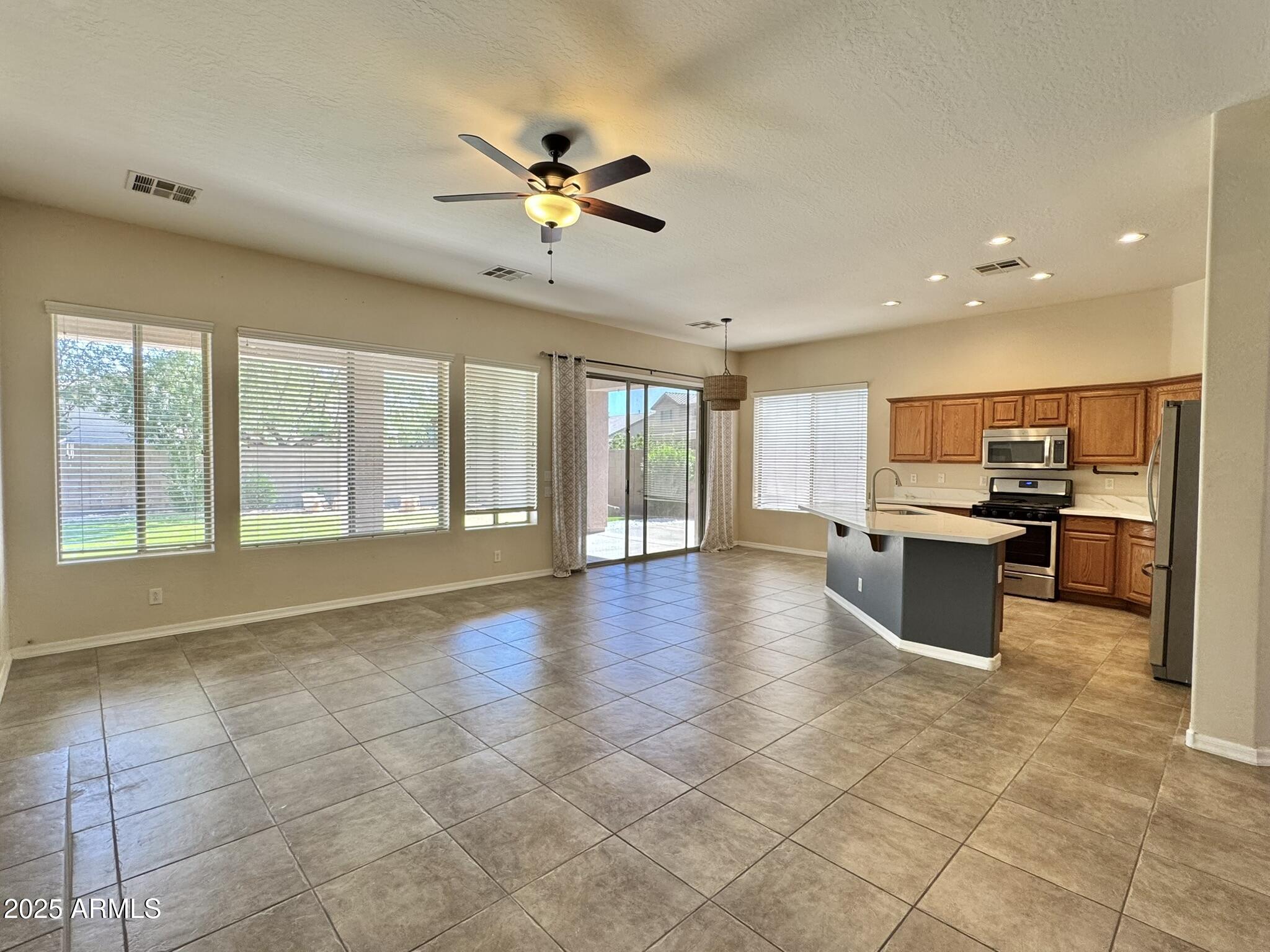 2671 South Dragoon Drive Chandler, AZ 85286 - Photo 11 of 41 a view of an empty room with kitchen and window