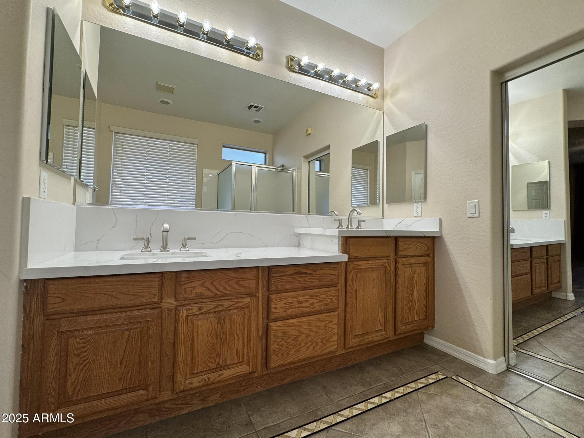 2671 South Dragoon Drive Chandler, AZ 85286 - Photo 14 of 41 a spacious bathroom with a double vanity sink a mirror and a shower
