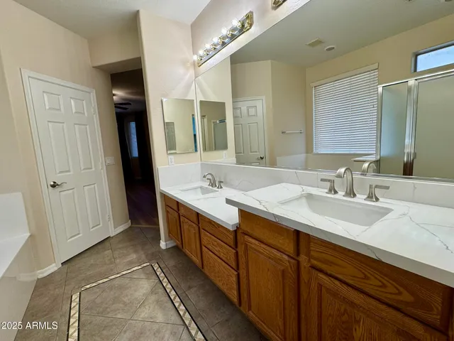 a bathroom with a double vanity sink and a mirror