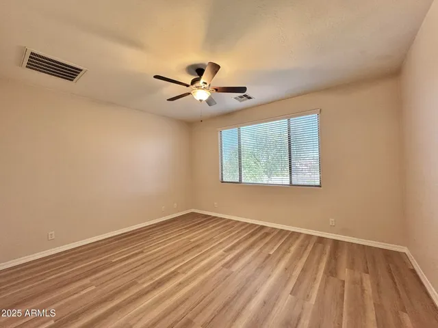 a view of a room with wooden floor and a window