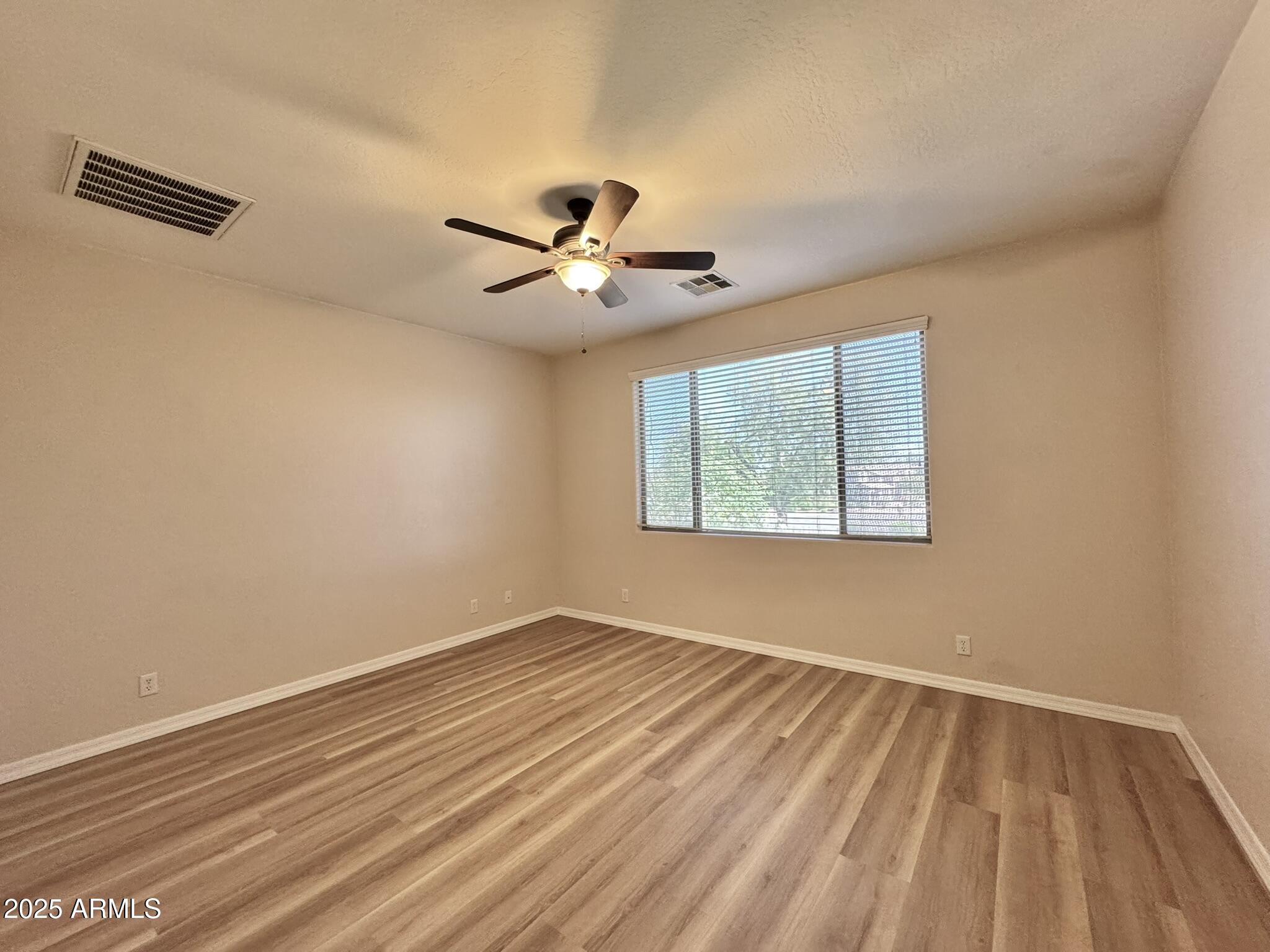 2671 South Dragoon Drive Chandler, AZ 85286 - Photo 19 of 41 a view of a room with wooden floor and a window