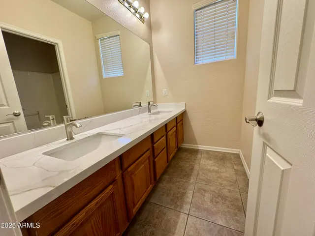a bathroom with a double vanity sink a and a mirror