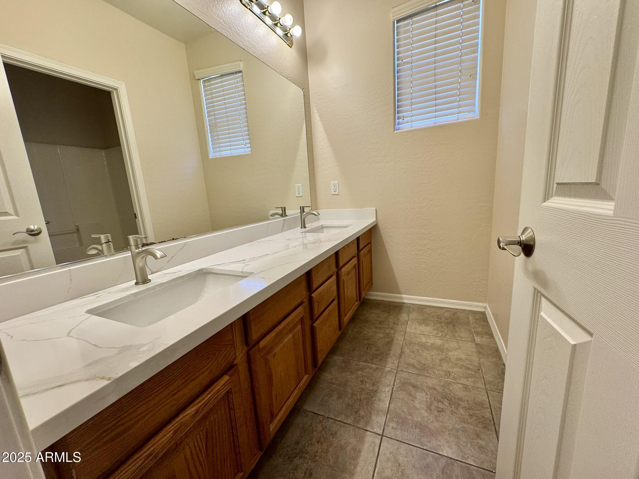 2671 South Dragoon Drive Chandler, AZ 85286 - Photo 26 of 41 a bathroom with a double vanity sink a and a mirror