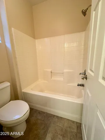 a bathroom with a toilet and a bathtub