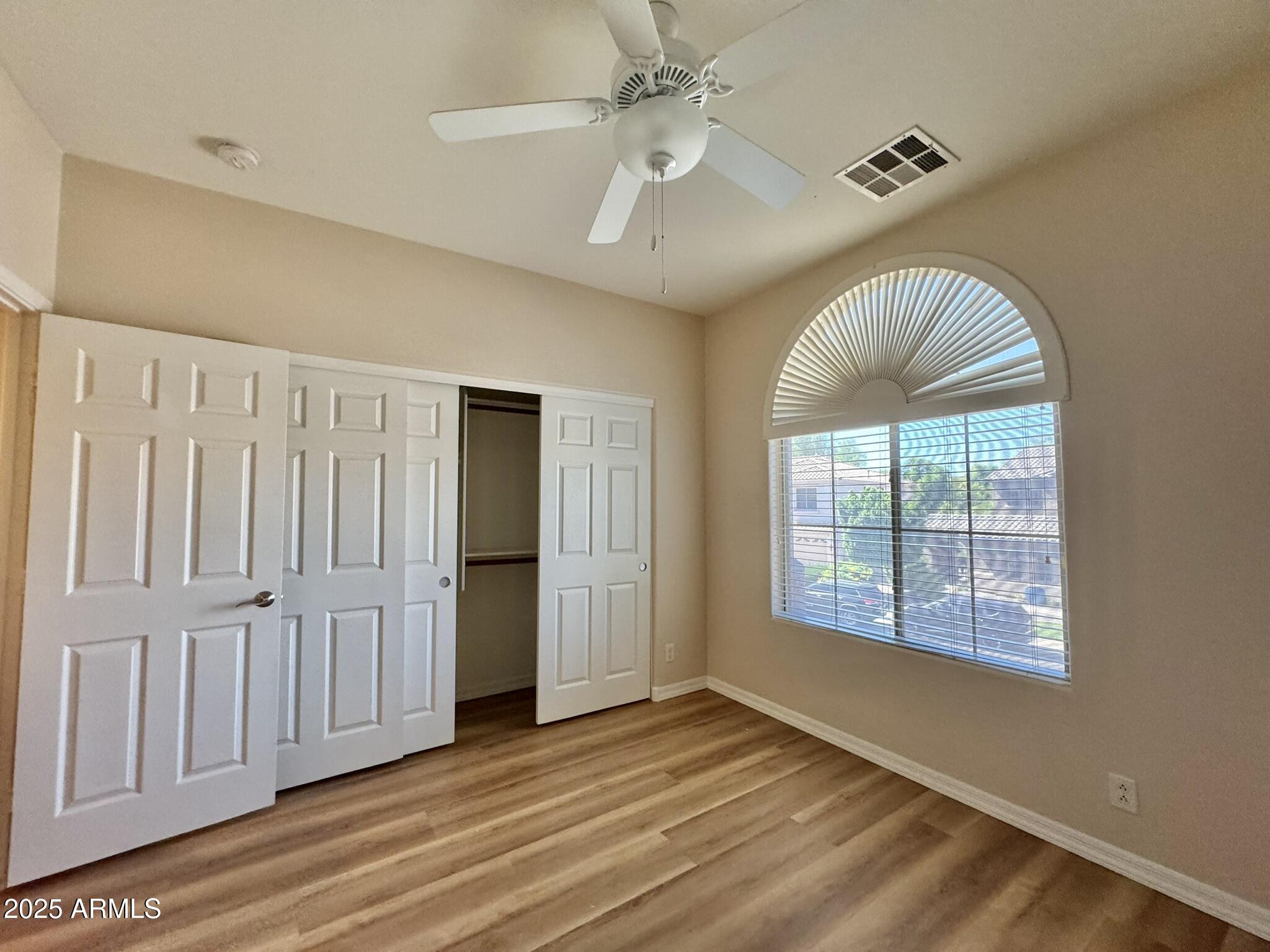 2671 South Dragoon Drive Chandler, AZ 85286 - Photo 29 of 41 wooden floor in an empty room with a window