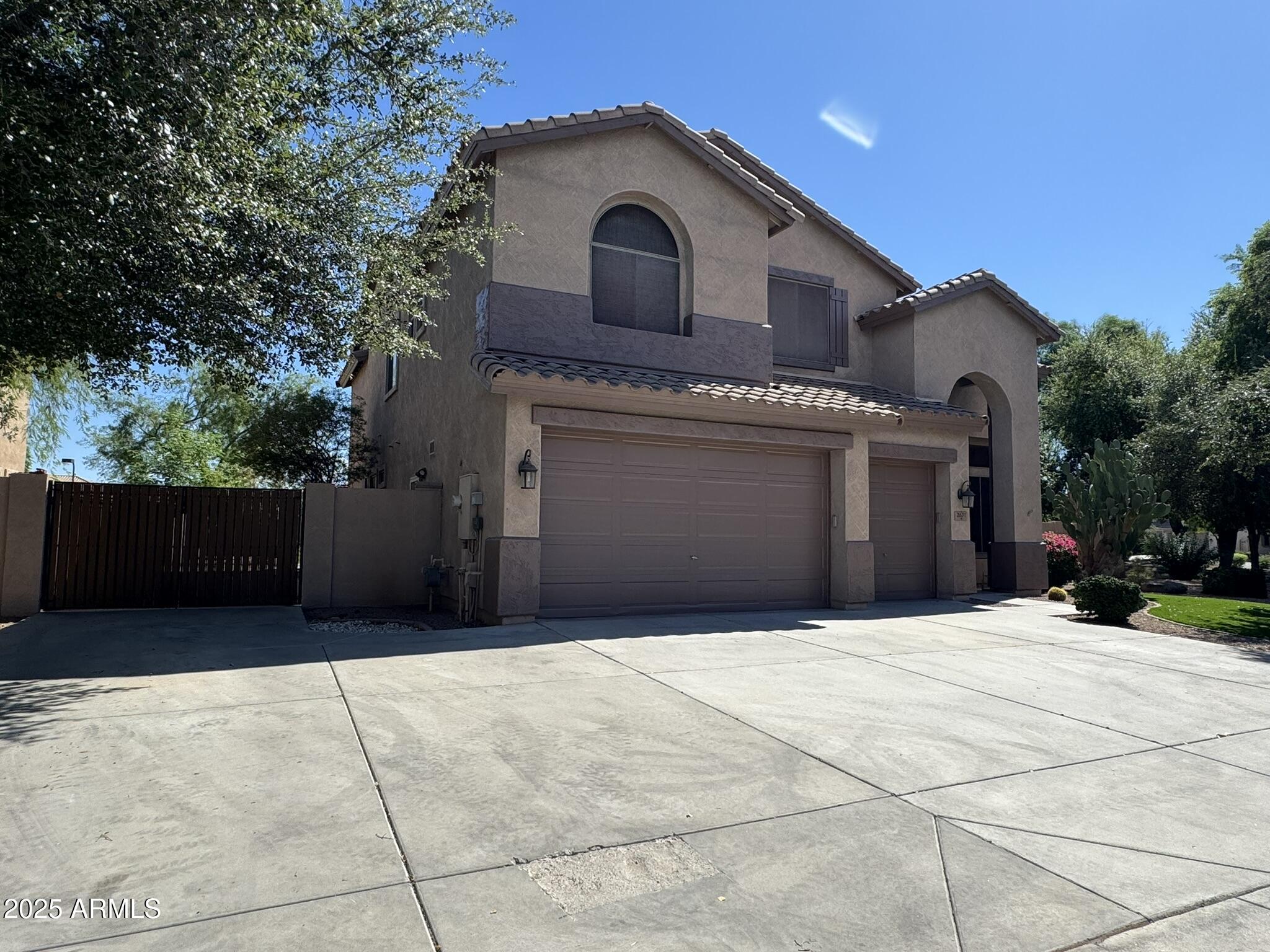 2671 South Dragoon Drive Chandler, AZ 85286 - Photo 3 of 41 a front view of a house with a yard and garage
