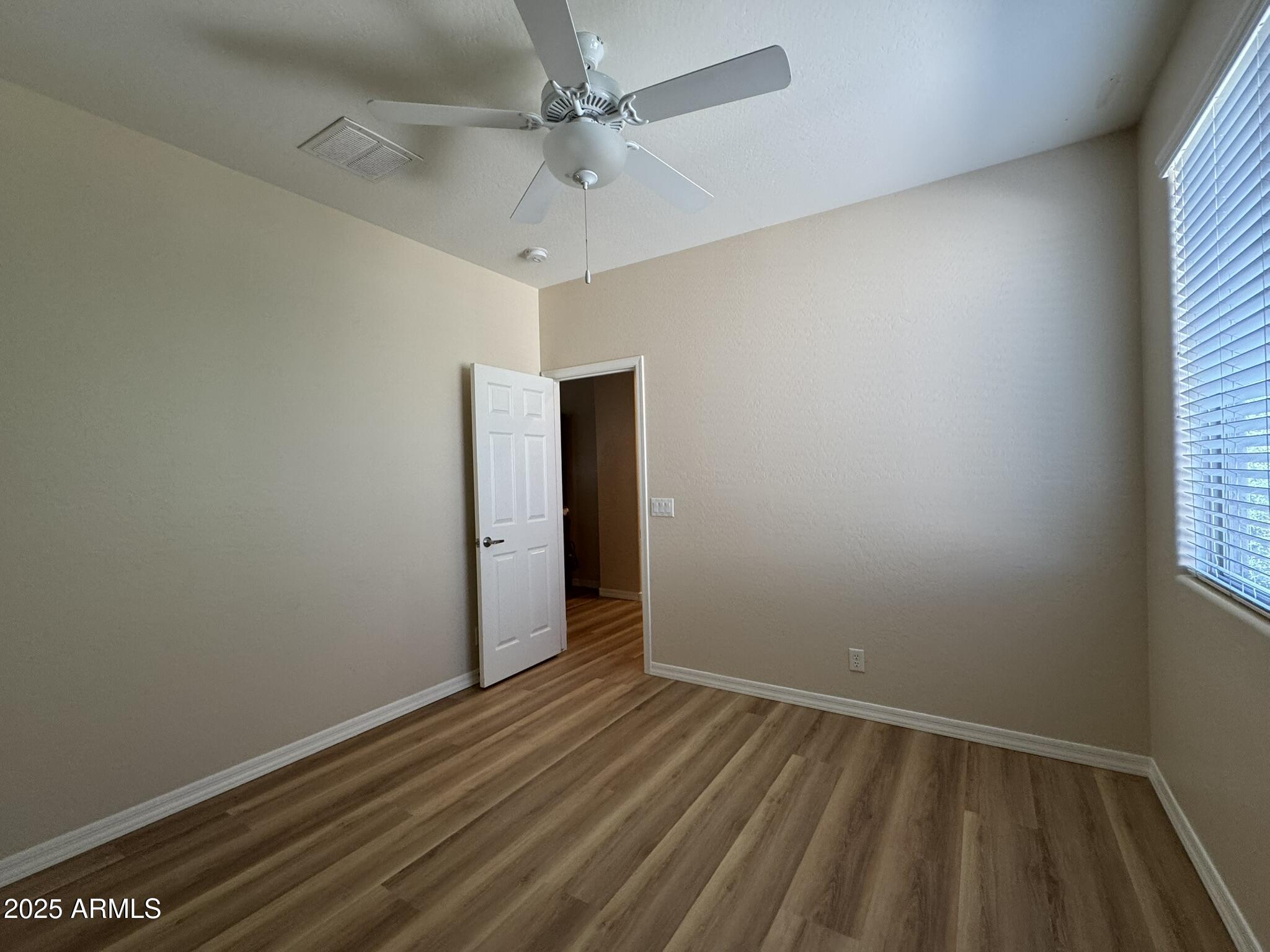 2671 South Dragoon Drive Chandler, AZ 85286 - Photo 32 of 41 an empty room with a window and a ceiling fan
