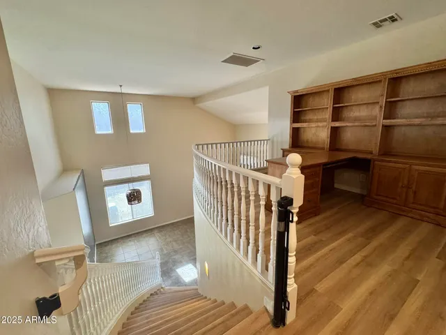 a view of a room with wooden floor and windows
