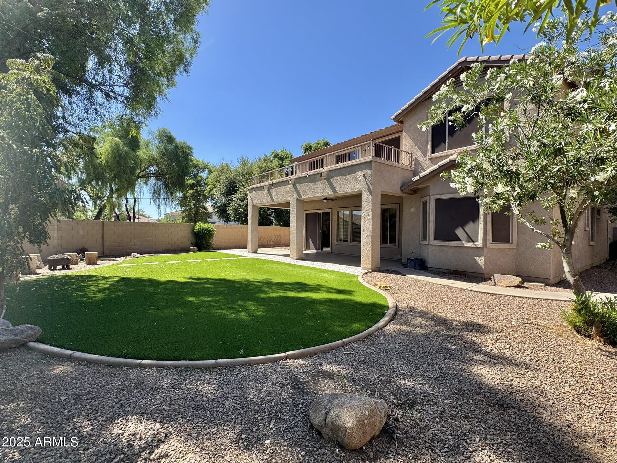 2671 South Dragoon Drive Chandler, AZ 85286 - Photo 38 of 41 a view of a white house with a big yard and potted plants