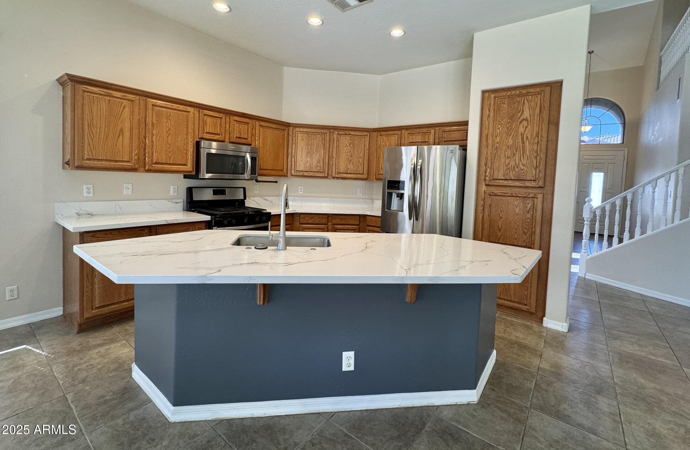 2671 South Dragoon Drive Chandler, AZ 85286 - Photo 6 of 41 a kitchen with kitchen island a sink stainless steel appliances and cabinets