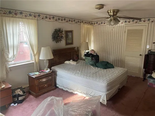 a bedroom with a bed and a window