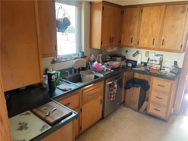 a kitchen with stainless steel appliances granite countertop a sink stove and cabinets