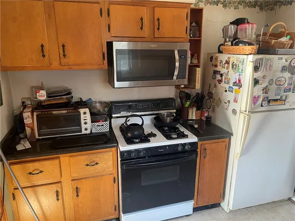 a kitchen with stainless steel appliances granite countertop a stove and a microwave