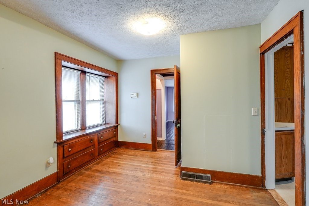851 Ranney Street Akron, OH 44310 - Photo 16 of 30 bedroom featuring a textured ceiling and light hardwood / wood-style floors