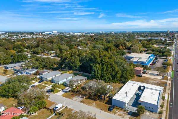 an aerial view of residential building and ocean
