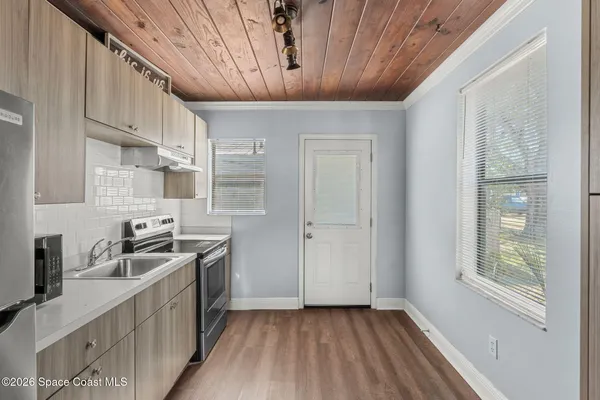 a kitchen with stainless steel appliances granite countertop a sink stove and cabinets