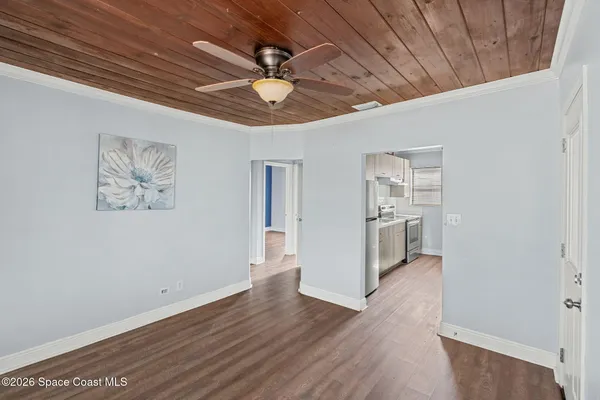 a view of a hallway with wooden floor