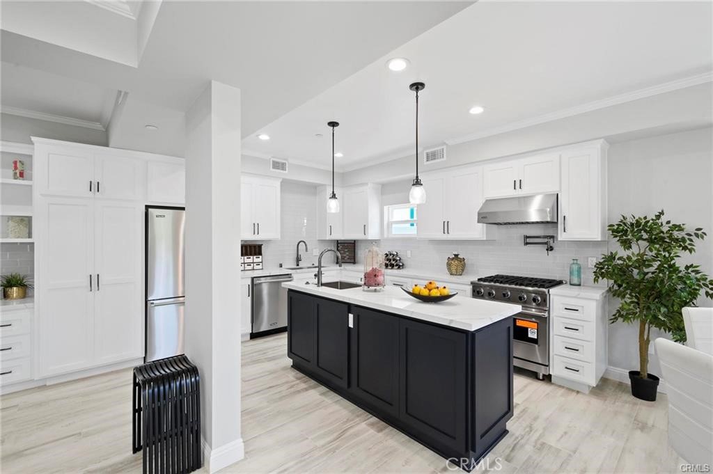 112 Van Nuys Avenue Oxnard, CA 93035 - Photo 11 of 58 a kitchen with stainless steel appliances sink stove top oven and refrigerator