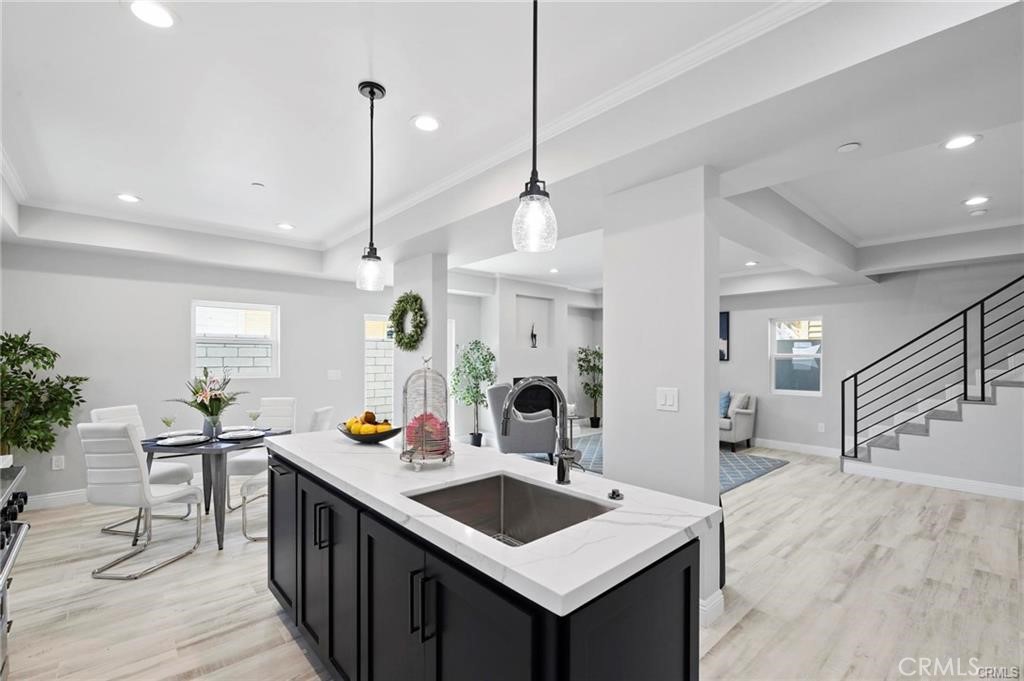 112 Van Nuys Avenue Oxnard, CA 93035 - Photo 14 of 58 a kitchen with a sink a counter space and a living room view