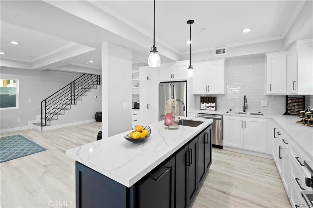 112 Van Nuys Avenue Oxnard, CA 93035 - Photo 16 of 58 a kitchen with a sink a center island and appliances