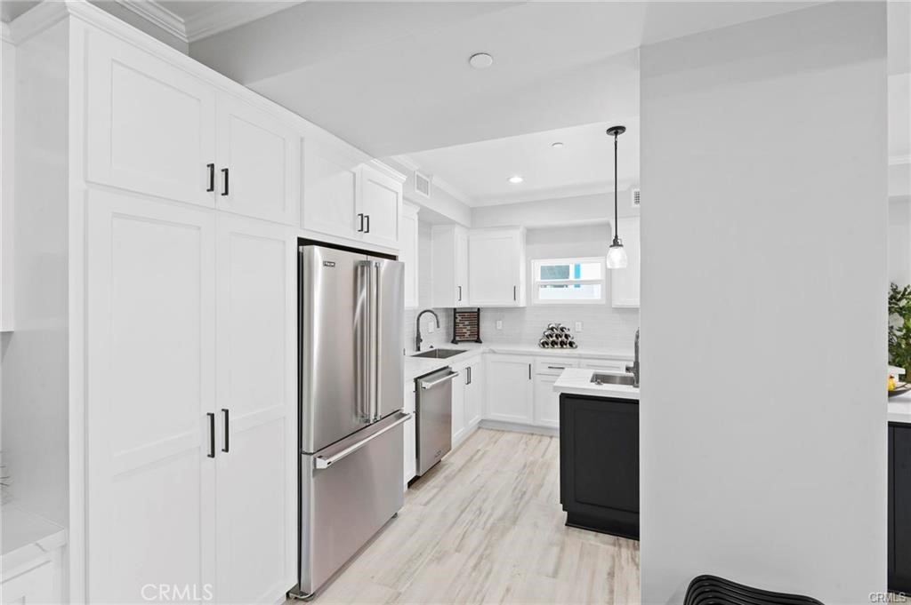 112 Van Nuys Avenue Oxnard, CA 93035 - Photo 19 of 58 a kitchen with cabinets stainless steel appliances and wooden floor