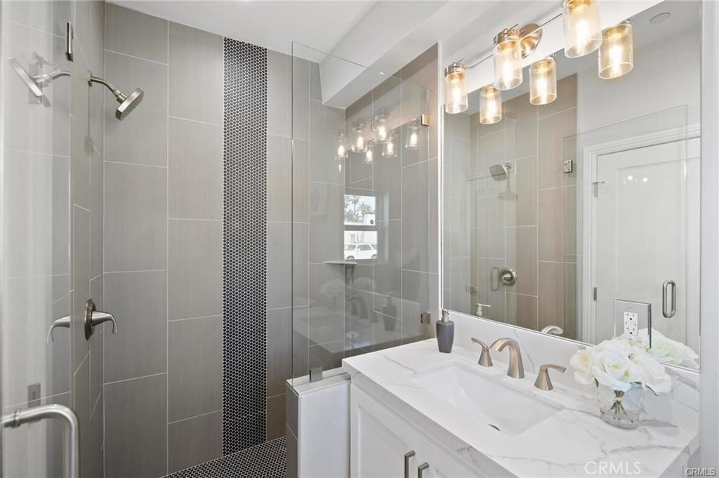 112 Van Nuys Avenue Oxnard, CA 93035 - Photo 29 of 58 a bathroom with a double vanity sink mirror and shower