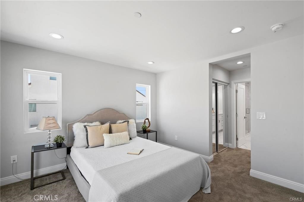 112 Van Nuys Avenue Oxnard, CA 93035 - Photo 32 of 58 a bedroom with a bed and a lamp