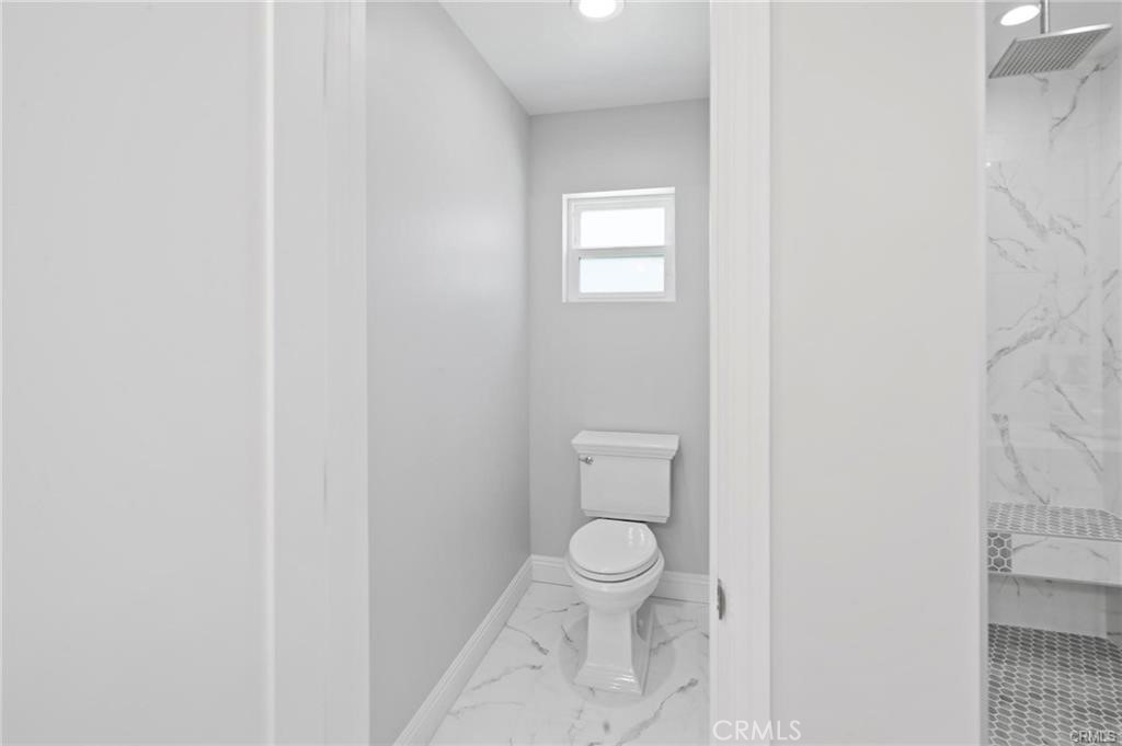 112 Van Nuys Avenue Oxnard, CA 93035 - Photo 37 of 58 a white toilet sitting next to a white wall