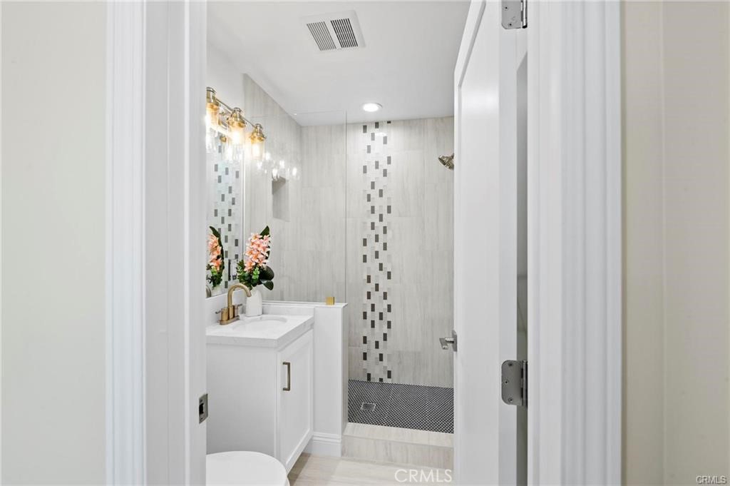 112 Van Nuys Avenue Oxnard, CA 93035 - Photo 41 of 58 a bathroom with a sink mirror and toilet