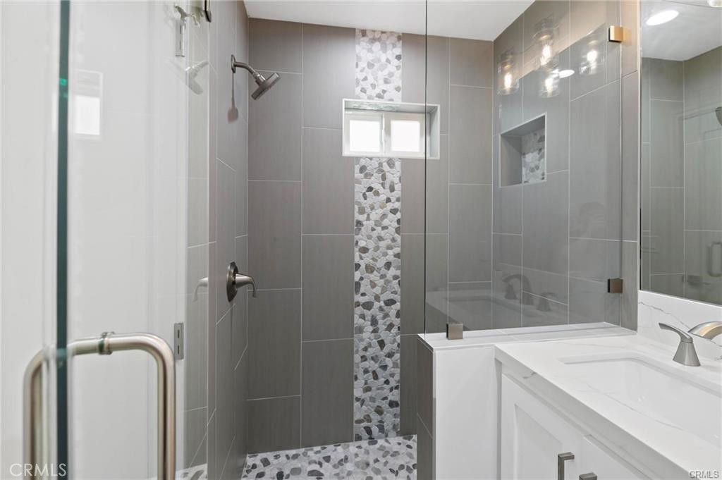 112 Van Nuys Avenue Oxnard, CA 93035 - Photo 43 of 58 a bathroom with a sink mirror and shower